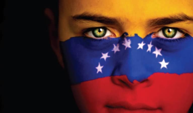 woman with a venezuelan flag painted on her face